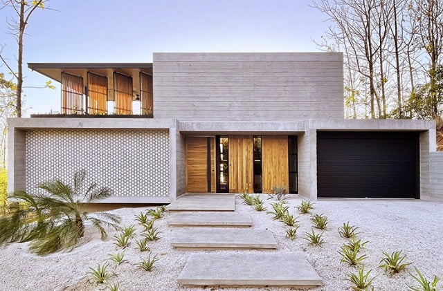 concrete residence's L-shaped infinity pool merges with costa rica's pacific coast