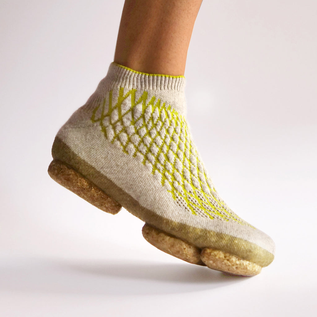 Sneature is a bio-shoe with a mycelium sole and a 3D-knitted canine hair body